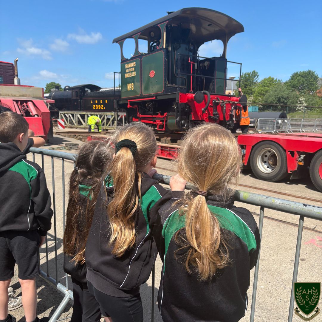 Children watching a train being delivered 