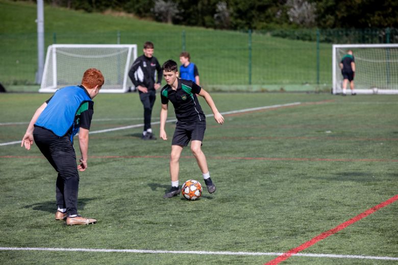 Senior pupils playing football 